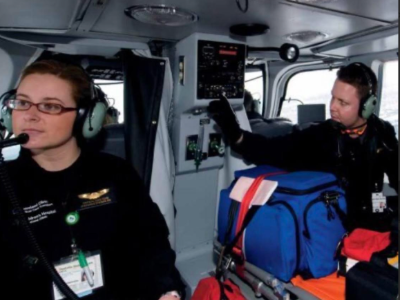 A man and woman sit in a medical helicopter.