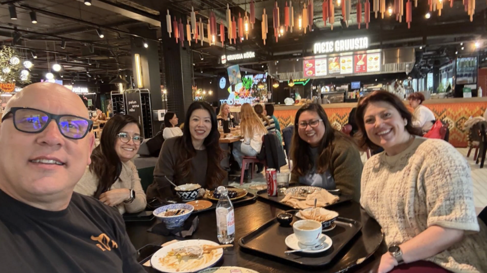 Students pose for a selfie during dinner