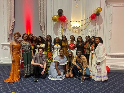 Photo of members of the African Student Association posing together in formal clothing
