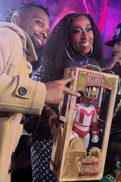 Photo of Michael Crawford with Missy Elliott holding a 3D-printed figure of her in a laser-engraved box
