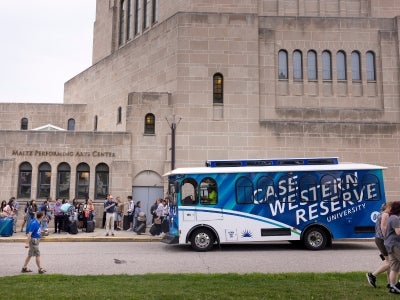 View of new CWRU-branded trolley picking up individuals during move-in weekend. Photography by Annie O'Neill.  