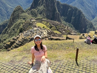 Catalina Luque takes a photo in front of Machu Picchu Mountain, located in southeastern Peru.