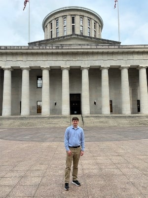 Noah Perrin standing in front of the Ohio Statehouse