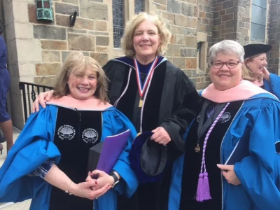 Carol Musil (center) and CWRU faculty at commencement. 