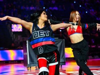 Marissa Orzame (left) dances with a teammate at a Detroit Pistons basketball game. 