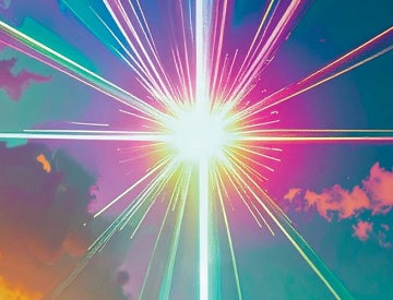 A colorful starburst pattern with multicolored beams emanating from a bright white center against a cloud-filled background.