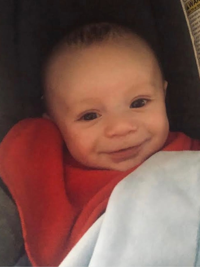 baby Luca smiling up at the camera