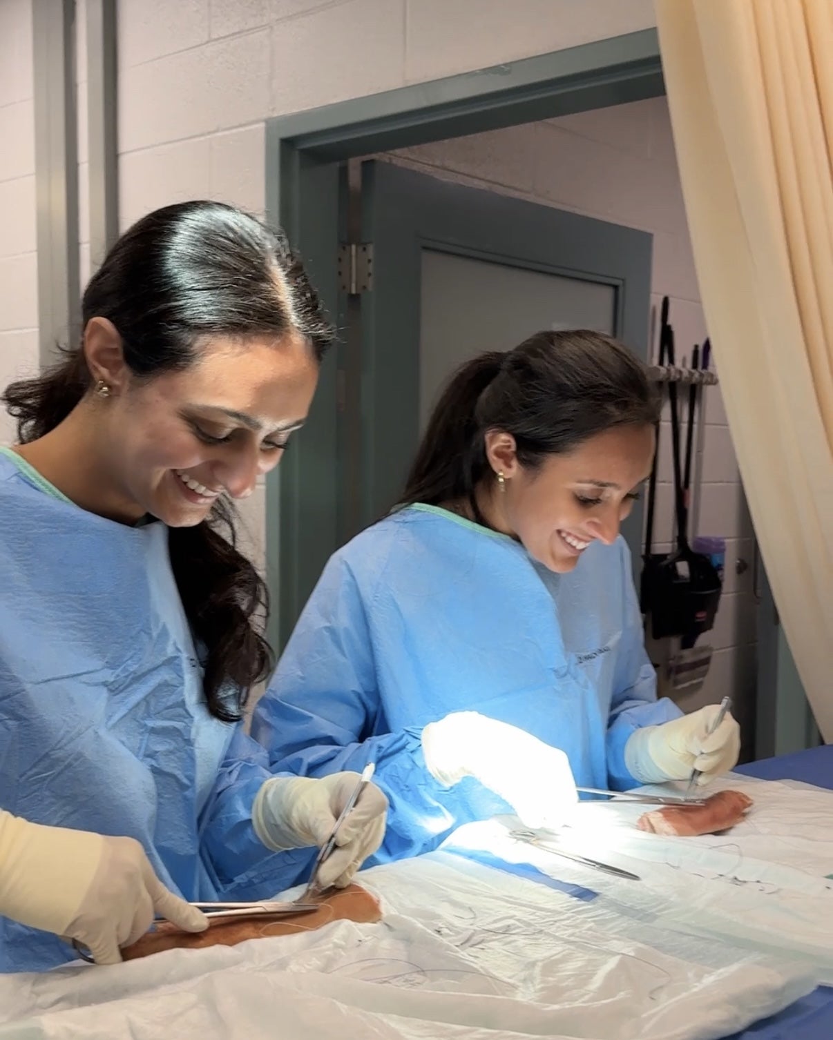 Riddhi Patel practicing clinical skills with a peer