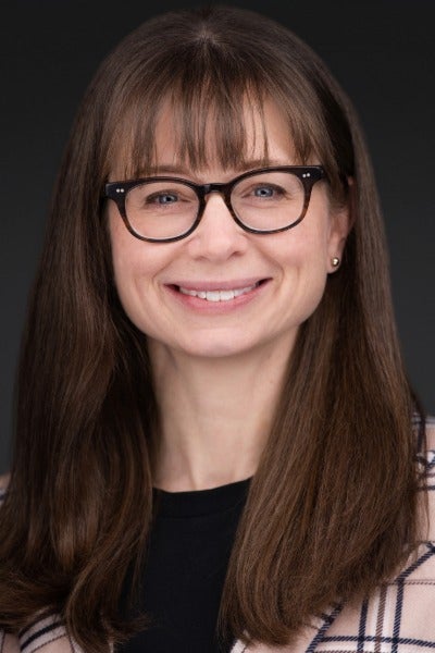 Woman with long brown hair wearing glasses 