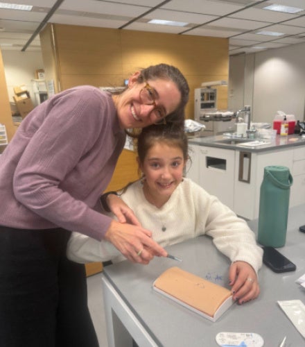 Hedy Leiter practices sutures with a child
