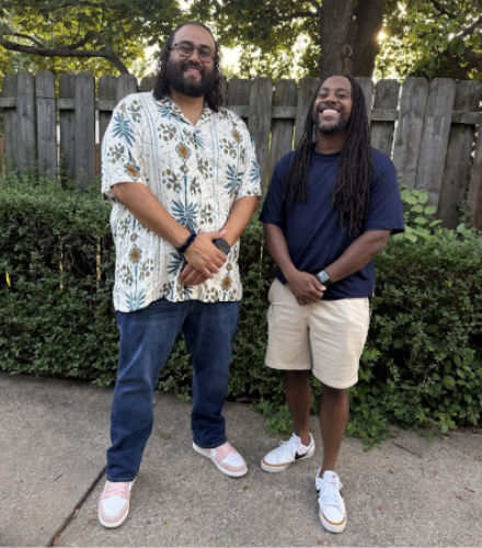 Juan Silva stands with a friend on a driveway.