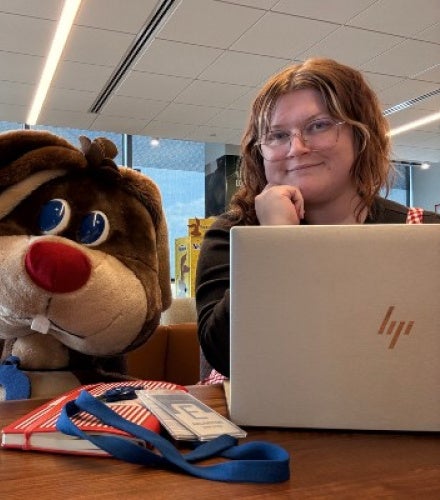 Heather O Brien with an open laptop and the Nestle Quick Rabbit