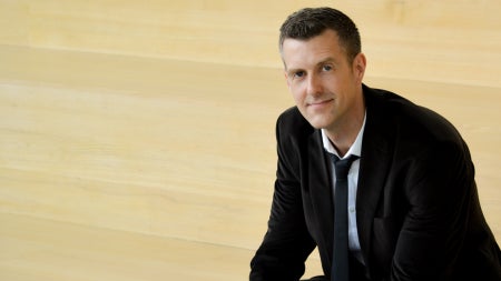 John Broich sitting on pale stairs