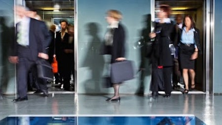 Business people walking through office.