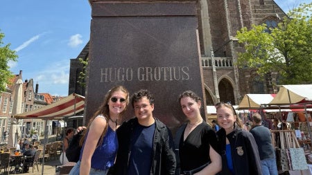 Standing in front of the famed Statute of Hugo Grotius, the Father of International Law, in The Netherlands, from Left to right: Kaylara Benfield, Oliber Bates, Teresa Lebowitz and Maria Blough