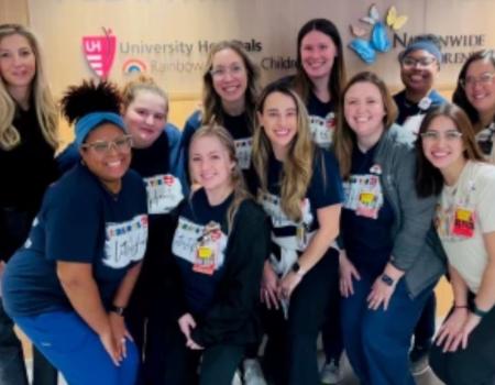 Cristin Coleman and other founding members of UH Rainbow Babies & Children’s Hospital's pediatric cardiac intensive care unit pose for a group photo.  