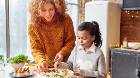 Woman and child making a salad