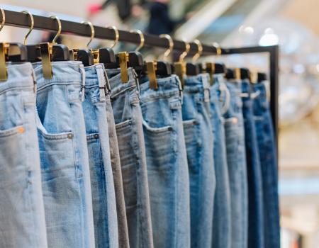 Denim jeans on a rack in a storefront