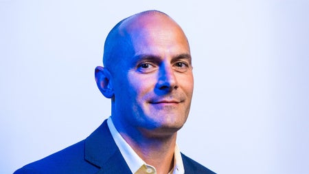 A photographic portrait of Jeff Capadona in blue suit 