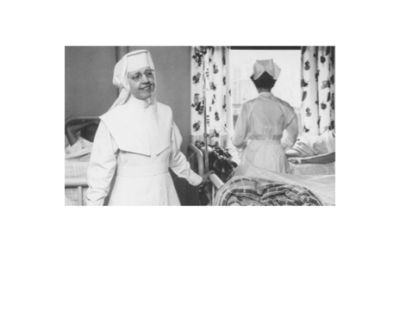 Black and White photo of smiling person wearing a habit 