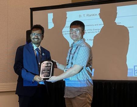 Photo of Rishab Kundu receiving an award