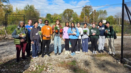 Photo of students volunteering at a local urban farm