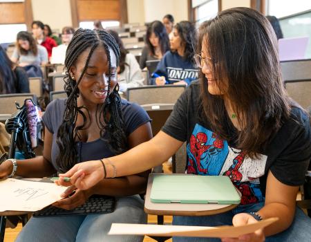Photo of two students interacting in a classroom