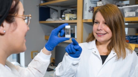 Agata Exner looking at materials in a lab with a student