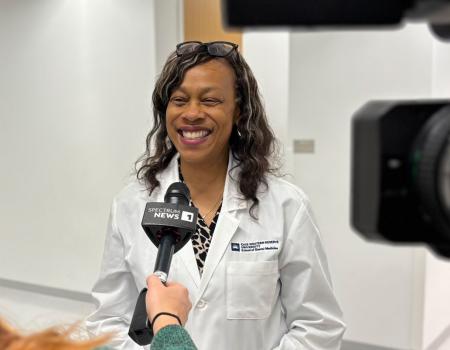 Photo of School of Dental Medicine faculty member Kristin Williams being interviewed by the news
