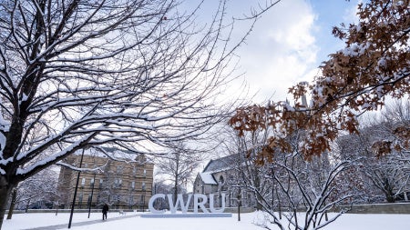 C-W-R-U letters sign covered in snow alongside the Binary Walkway.