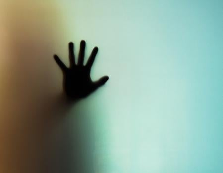 hand up against a window