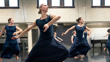 Photo of CWRU dancers mid-leap rehearsing for Martha Graham dance