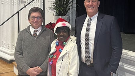 Fred Peck, Arlene Williams and Dean Tufts pose for a photo at the campus planning and facilities management holiday party