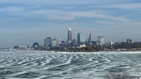 Photo of an icy Lake Erie with the Cleveland skyline in the background