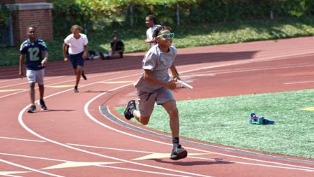 NYSP participants run on a track field