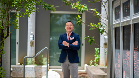 Osvaldo standing outside with his arms crossed 