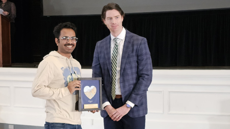 Image of Rishabh Kundu holding an award next to Tim Dengler