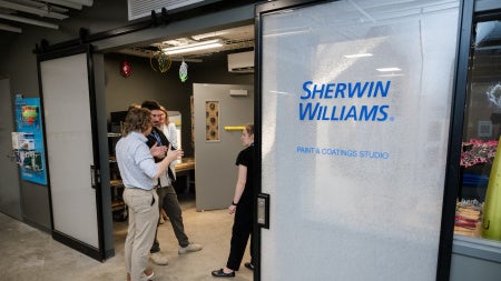 Visitors stand at entrance of Sherwin Williams Paint & Coatings Studio at Sears think[box]. 
