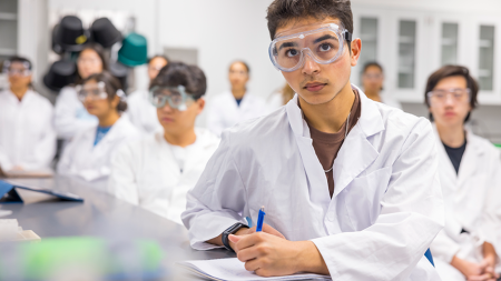 Image of a student taking notes in a lab