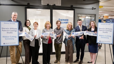 People stand for a ribbon cutting of the new Sherwin-Williams Paint and Coatings Studio in think[box]