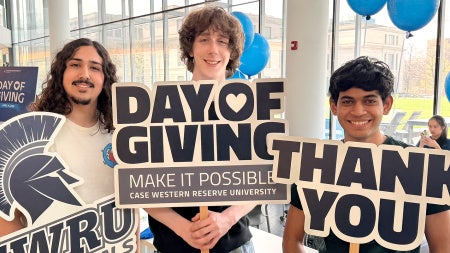 Students holding signs expressing thanks