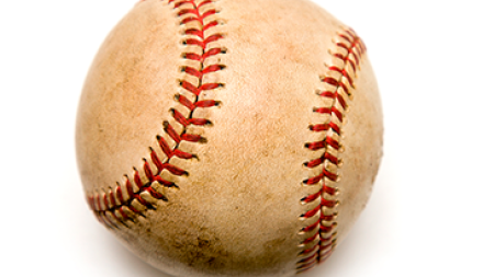 A worn, vintage-style baseball with a cream-colored leather surface showing signs of scuffing and dirt.