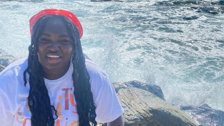 Ruth Boampong poses for a photo in front of a body of water