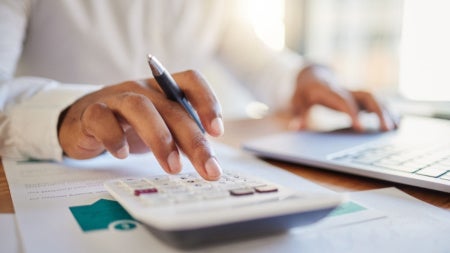 Budgeting illustration concept with someone working on a calculator
