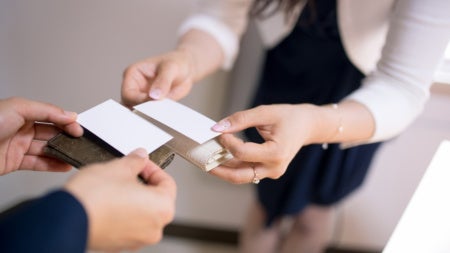 Close up of people exchanging business cards
