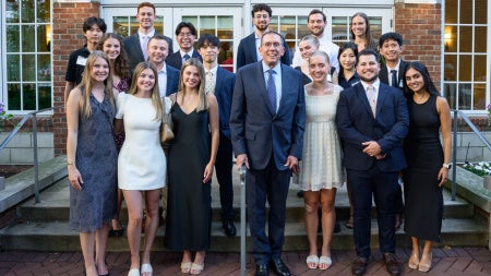 Group of students standing next to dean baur