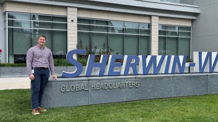 Connor Black standing in front of Sherwin-Williams signage