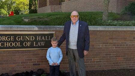 Ray November and his grandson, Liam, outside of the School of Law