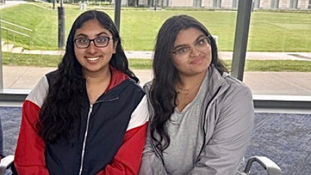 Aditi Bohre and Mahek Goel sit at a table in Tinkham Veale University Center