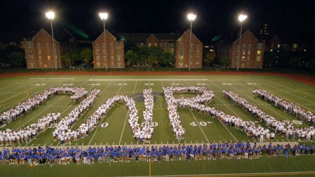 Photo of the Class of 2030 spelling out the CWRU letters on DiSanto Field